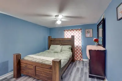 a bedroom with a bed in a blue room at 9 Mi to Hersheypark Spacious Home with Deck in Harrisburg