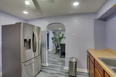 a kitchen with a stainless steel refrigerator and a table at 9 Mi to Hersheypark Spacious Home with Deck in Harrisburg