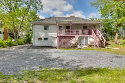 a house with a pink deck and a driveway at 9 Mi to Hersheypark Spacious Home with Deck in Harrisburg