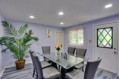 a dining room with a glass table and chairs at 9 Mi to Hersheypark Spacious Home with Deck in Harrisburg