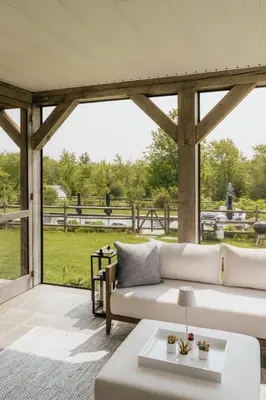a living room with a white couch and a table at Elevated Catskills Getaway On 15-acre Private Farm in Parksville