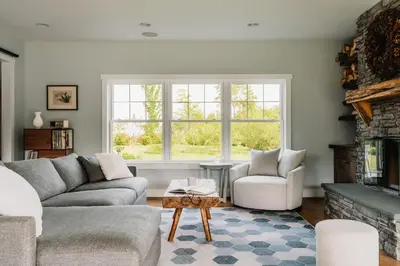 a living room with a couch and a fireplace at Elevated Catskills Getaway On 15-acre Private Farm in Parksville
