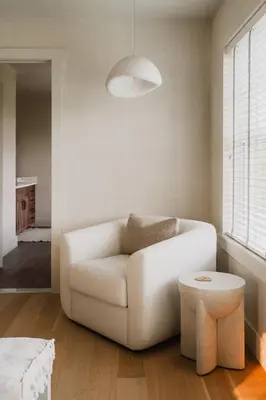 a living room with a white couch and a stool at Elevated Catskills Getaway On 15-acre Private Farm in Parksville