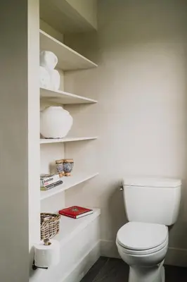 a bathroom with a white toilet and shelves at Elevated Catskills Getaway On 15-acre Private Farm in Parksville