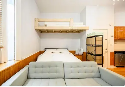 a bedroom with a bed and a loft bed at Yard, Laundry, Large! Bonus Sleep Area in Jersey City