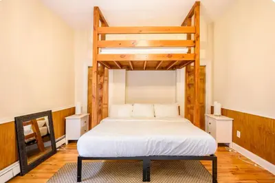 a bedroom with a loft bed with a white bedspread at Yard, Laundry, Large! Bonus Sleep Area in Jersey City