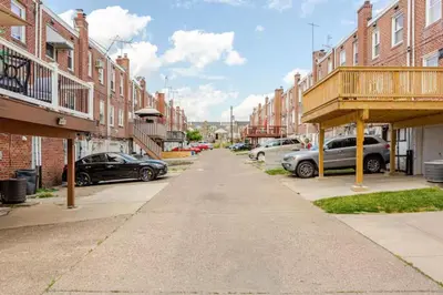 a city street with parked cars and buildings at Staycation Suite in Philadelphia