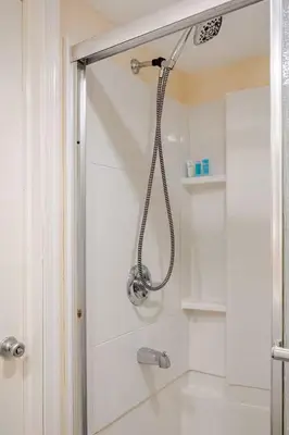 a shower in a bathroom with a glass door at Staycation Suite in Philadelphia