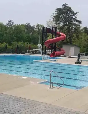 a large swimming pool with a red water slide at Masthope Heritage Chalet in Lackawaxen