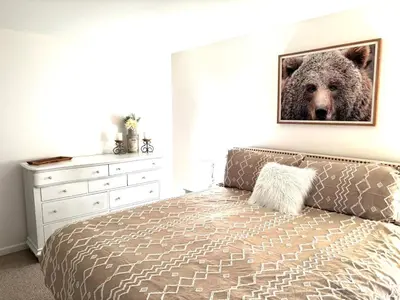 a bedroom with a bed with a picture of a bear on the wall at Masthope Heritage Chalet in Lackawaxen