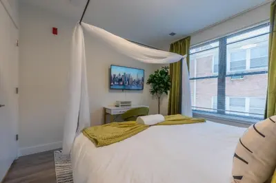 a bedroom with a white bed with a canopy at Opulence in Olive 4 bedrooms, 4 baths with 10 beds, Park 2 cars FREE in Orange