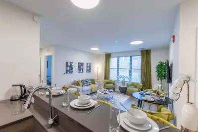 a kitchen and living room with a living room at Opulence in Olive 4 bedrooms, 4 baths with 10 beds, Park 2 cars FREE in Orange