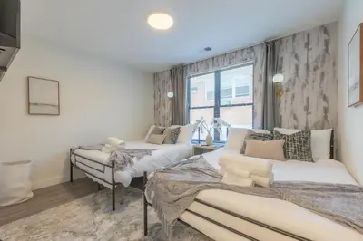 a bedroom with two beds and a window at Opulence in Olive 4 bedrooms, 4 baths with 10 beds, Park 2 cars FREE in Orange