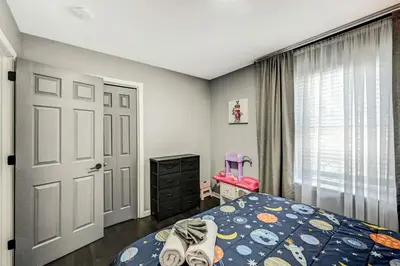 a bedroom with a bed and a door and a window at Leisurely Living in Long Pond in Long Pond