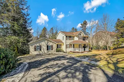 a large house with a driveway in front of it at Leisurely Living in Long Pond in Long Pond