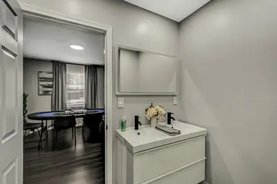 a bathroom with a white sink and a table at Leisurely Living in Long Pond in Long Pond
