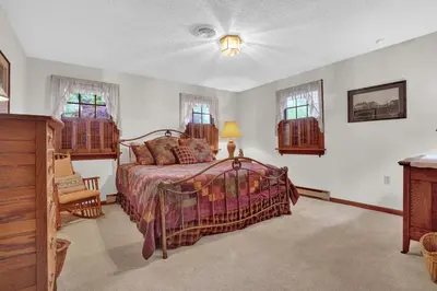 a bedroom with a bed and two windows at Spacious Antique Charm Home by Leavetown Vacations in Columbia