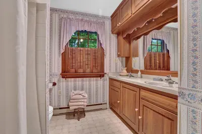 a bathroom with a sink and a window at Spacious Antique Charm Home by Leavetown Vacations in Columbia