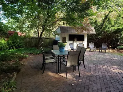 a table and chairs sitting on a brick patio at Spacious Antique Charm Home by Leavetown Vacations in Columbia