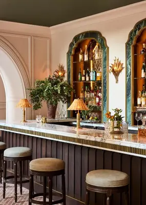 a bar at a hotel with stools at The Wall Street Hotel by Suiteness in New York