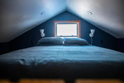 a blue bedroom with a bed and a window at Cozy Cabin Gateway with Pool and Firepit in Montgomery