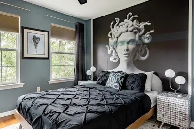 a bedroom with a statue of a head on a bed at Modern-Chic Living in the Heart of Center City in Philadelphia