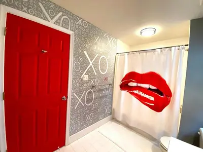 a bathroom with a red door and a red mouth on the wall at Modern-Chic Living in the Heart of Center City in Philadelphia
