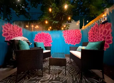 a patio with chairs and a fence with pink at Modern-Chic Living in the Heart of Center City in Philadelphia