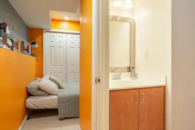 a small bathroom with a sink and a mirror at Modern-Chic Living in the Heart of Center City in Philadelphia