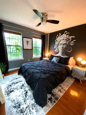 a bedroom with a large bed with a head on the wall at Modern-Chic Living in the Heart of Center City in Philadelphia