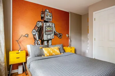 a bedroom with a bed with a robot on the wall at Modern-Chic Living in the Heart of Center City in Philadelphia
