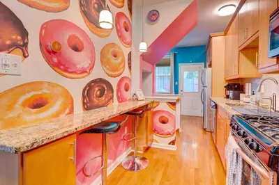 a kitchen with a wall with donuts on the wall at Modern-Chic Living in the Heart of Center City in Philadelphia