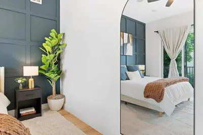 a bedroom with a bed and a mirror at Luxury 3BR Backyard Oasis Close to NYC FirePit in Jersey City