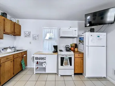 a kitchen with a white refrigerator and a stove at Susquehanna Riverside Condo by Leavetown Vacations in Columbia