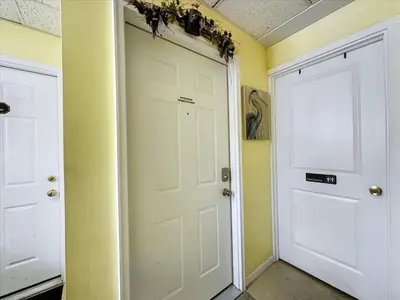 two white doors in a room with yellow walls at Susquehanna Riverside Condo by Leavetown Vacations in Columbia