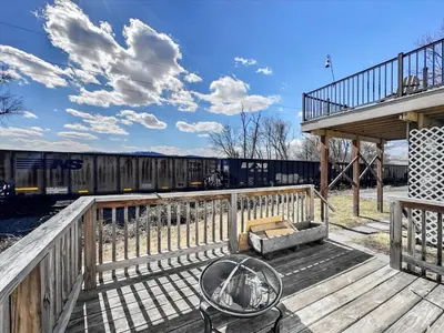 a wooden deck with a train on the tracks at Susquehanna Riverside Condo by Leavetown Vacations in Columbia
