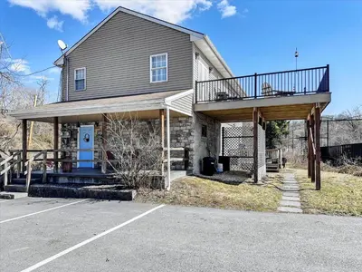 a house with a balcony on top of it at Susquehanna Riverside Condo by Leavetown Vacations in Columbia