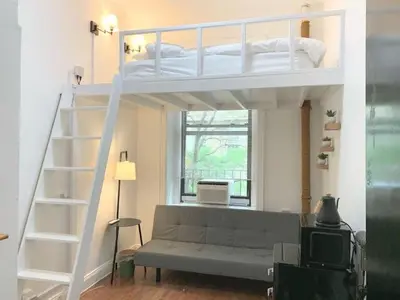 a living room with a bunk bed and a couch at Private room with Shared bath on Union Square 11 in New York