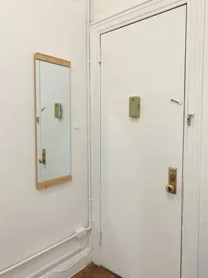 a mirror on a wall next to a door at Private room with Shared bath on Union Square 11 in New York