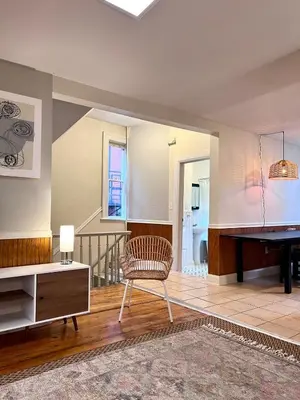 a living room with a piano and a chair at Ten Minute Commute to NYC in Jersey City