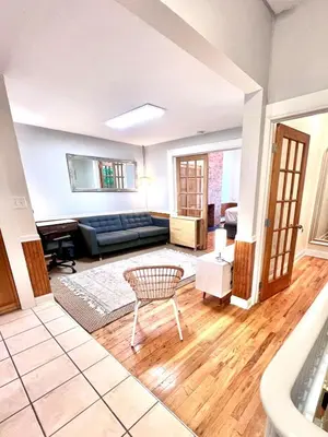 a living room with a couch and a table at Ten Minute Commute to NYC in Jersey City
