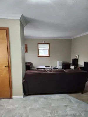 a living room with a large couch and a window at 2BR in Peaceful Country Near Ithaca in Willseyville