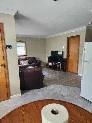 a living room with a couch and a refrigerator at 2BR in Peaceful Country Near Ithaca in Willseyville