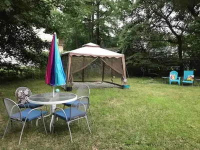 a table and chairs with an umbrella and a tent at Grande Lux Room- Boutique Hotel Style-15mins to NYC in Englewood