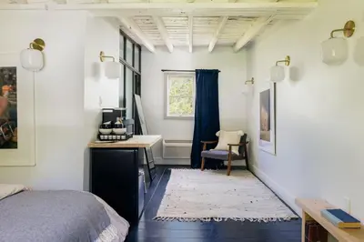 a bedroom with a bed and a desk and a window at Coop 002 in Kenoza Lake