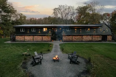 a fire pit in front of a house with a building at Coop 002 in Kenoza Lake