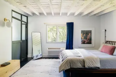 a bedroom with a bed and a window at Coop 003 in Kenoza Lake
