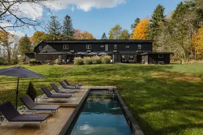 a house with a swimming pool in the yard at Coop 004 in Kenoza Lake