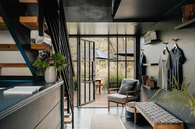 a living room with a couch and a chair at Coop 004 in Kenoza Lake