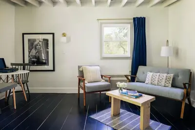 a living room with a couch and a table at Suite 001 in Kenoza Lake